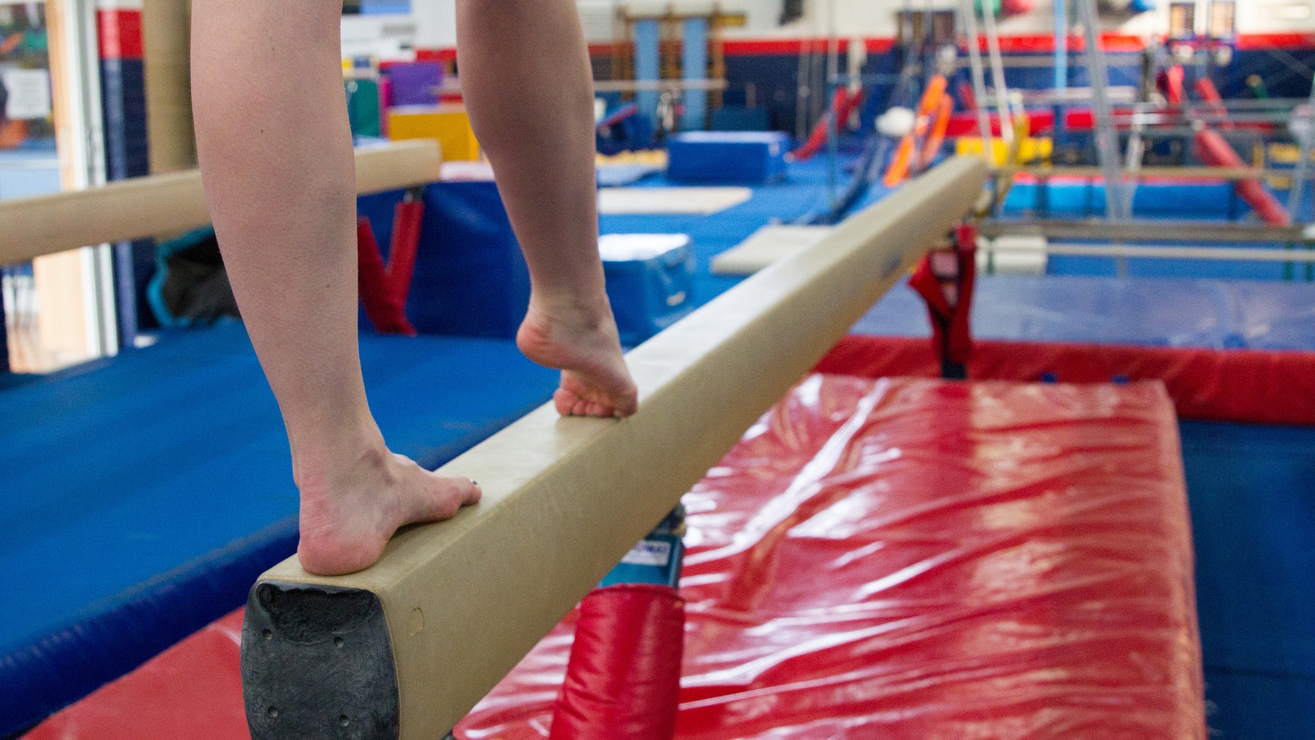 Someone walking on a plank in gymnastics.png