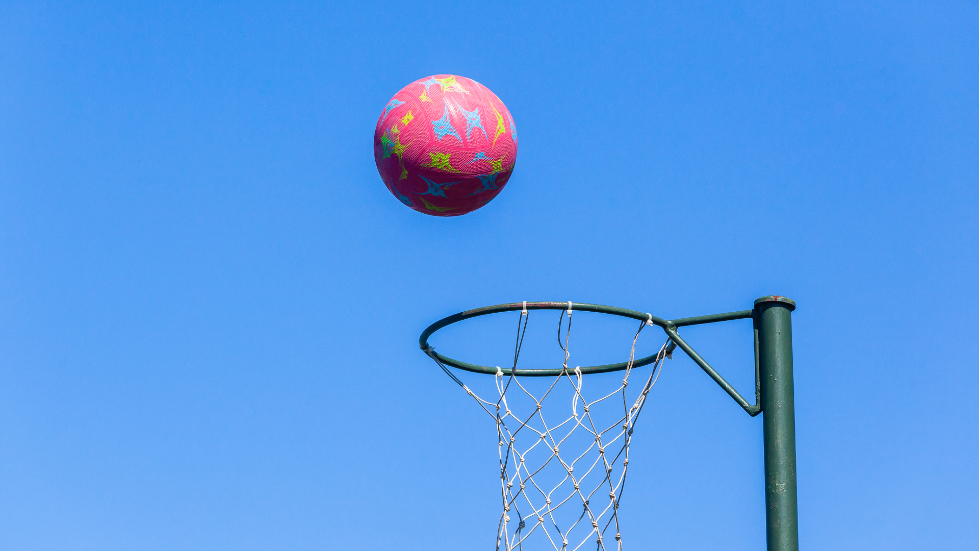 Pink Netball in the air.png